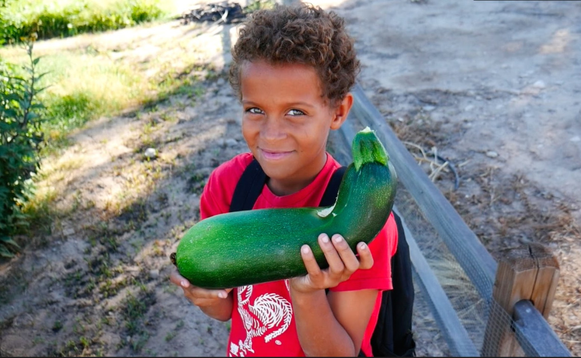 Boy with zucchini 